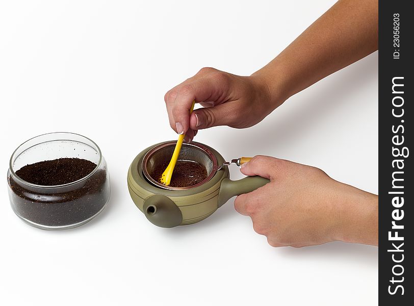 Close-up of a person's hand preparing tea. Close-up of a person's hand preparing tea
