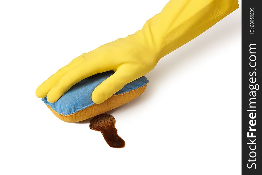 Hand in yellow glove with sponge cleaning coffe spot  on white background