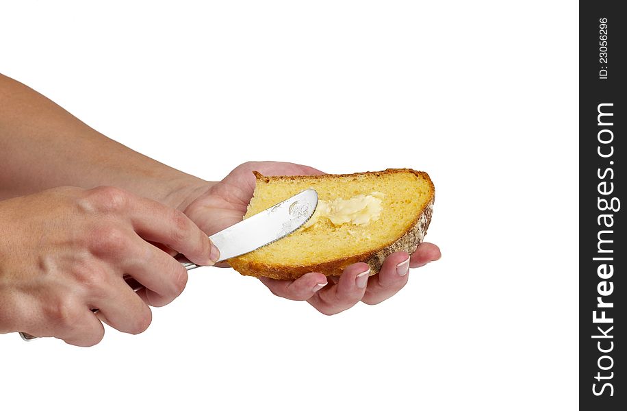 Spreading butter on bread white backround. Spreading butter on bread white backround