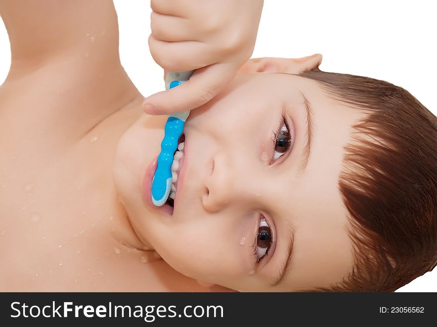 Smiling boy is cleaning his teeth with a nice blue toothbrush isolated on white. Smiling boy is cleaning his teeth with a nice blue toothbrush isolated on white