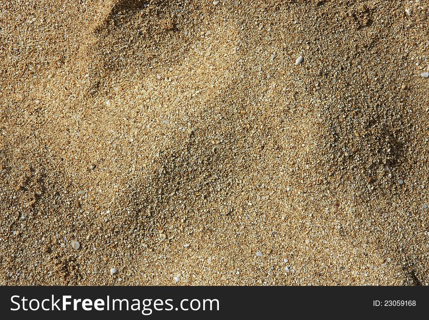 Background of a close-up of sand and small pebbles