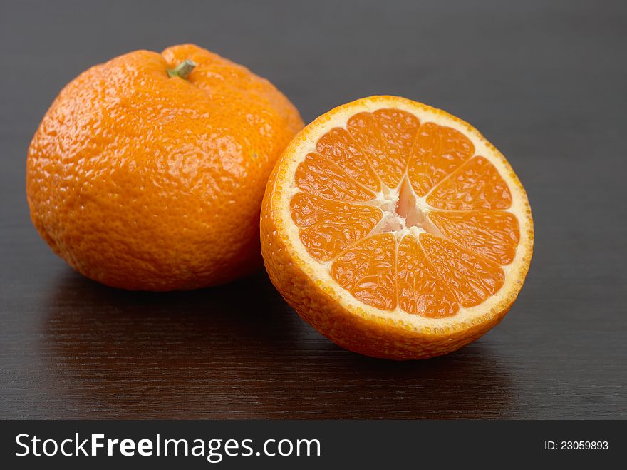 Mandarins on the background of dark wood