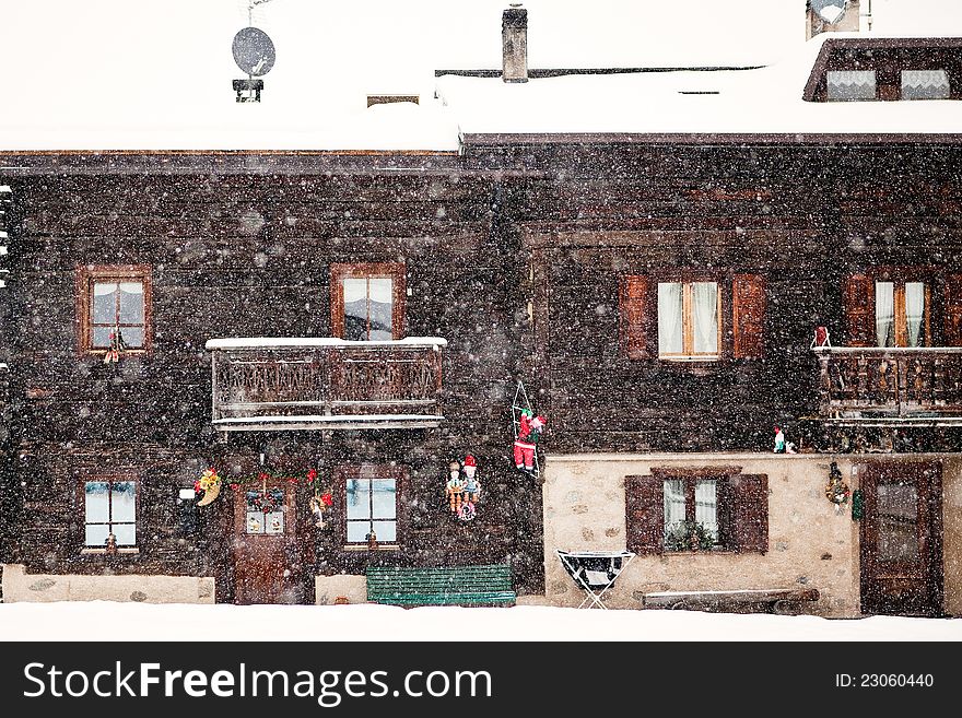 Snowing in front of traditional house
