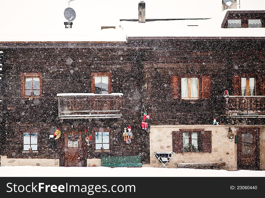 Snowing In Front Of Traditional House