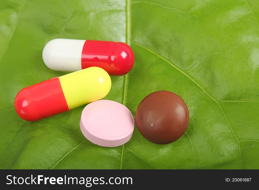 Capsules of a vegetative medical product on green sheet. Capsules of a vegetative medical product on green sheet