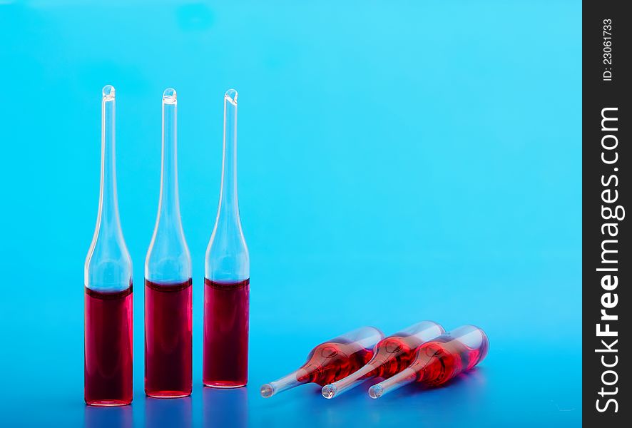 Medical ampoules on a blue background are closed