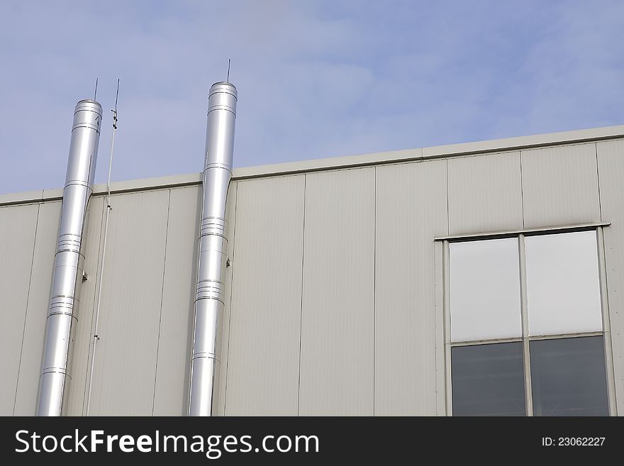 Two metal chimneys of a factory building. Two metal chimneys of a factory building