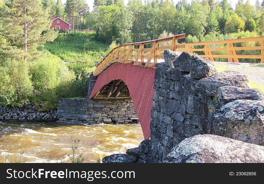 Old wooden bridge over a river in Norway. Old wooden bridge over a river in Norway