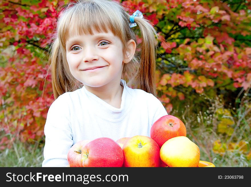 Little Girl With Fresh Vegetables In Garden