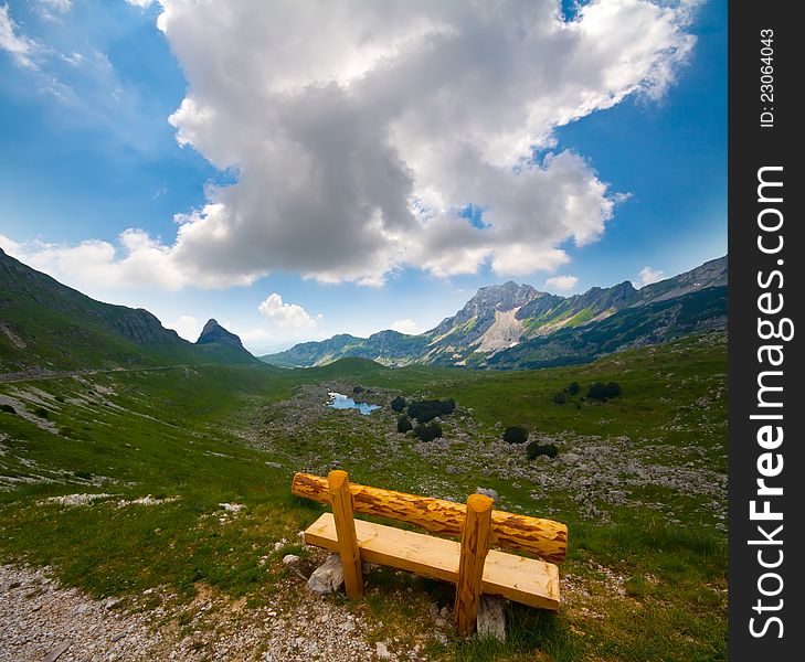 Solitary bench  on Alps valley