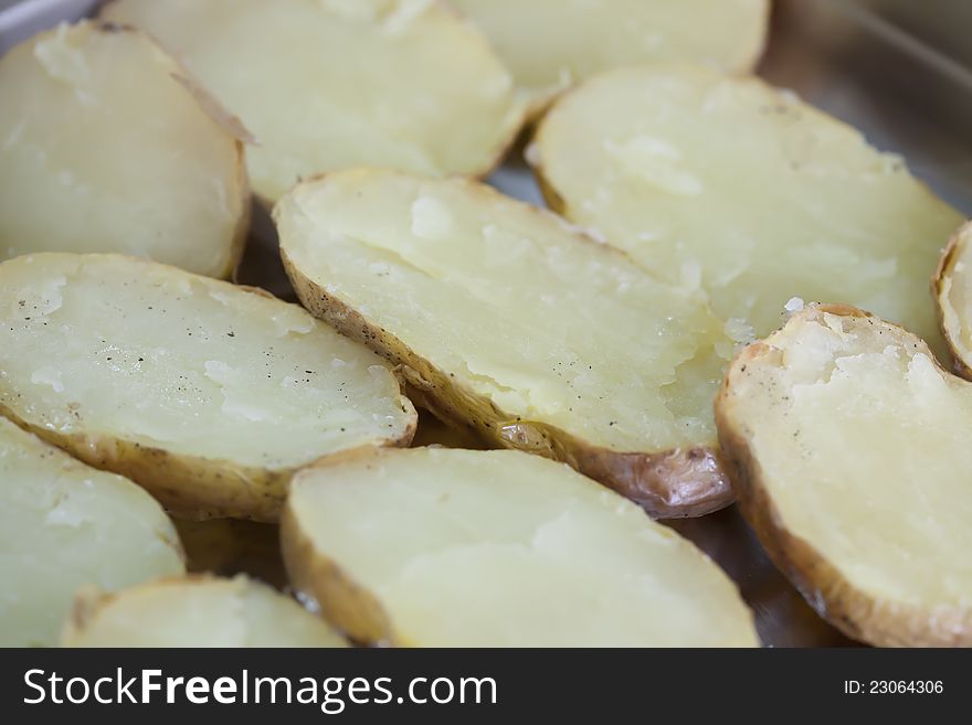 Roast potatoes in a pan with salt and pepper. Roast potatoes in a pan with salt and pepper