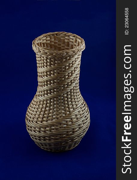 Wicker vase isolated on a blue background