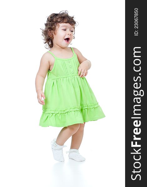 Little funny girl dancing in studio on white