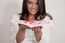 Young Girl With Card With Pop Up Hearts Royalty Free Stock Photos