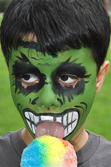Green Boy Enjoying A Colorful Ice Royalty Free Stock Images Green Boy Enjoying A Colorful Ice Royalty Free Stock Images
