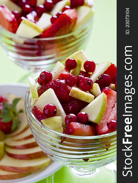 Photograph of two bowls of a colorful fruit salad. Photograph of two bowls of a colorful fruit salad