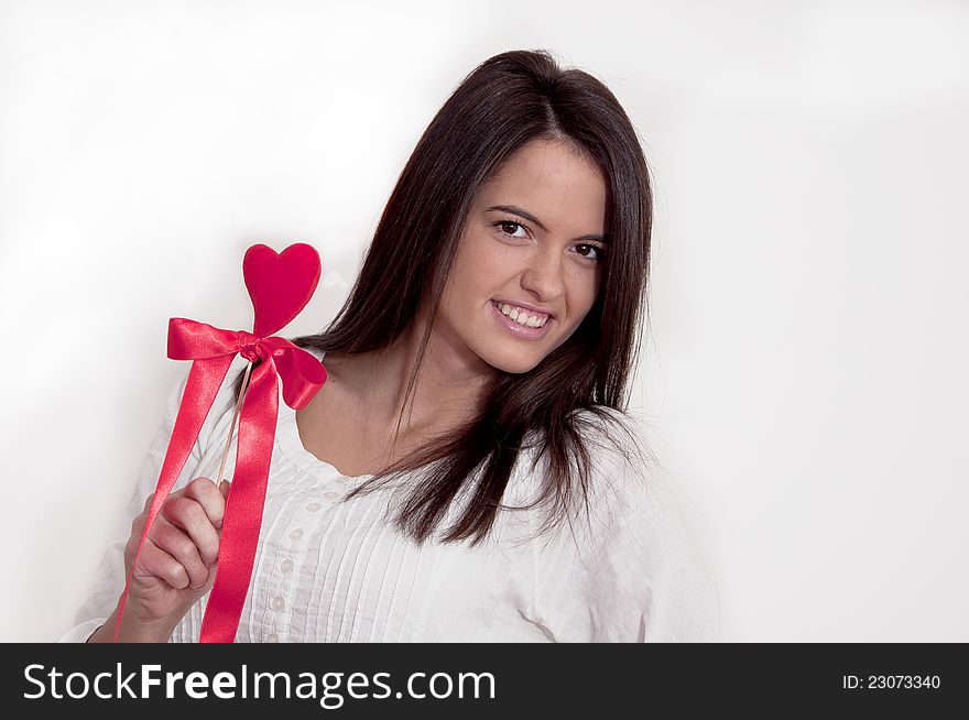 Young girl photographed on white background with Valentine heart