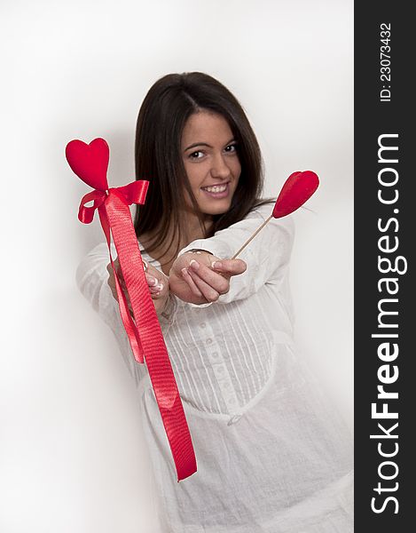 Young girl photographed on white background with Valentine hearts