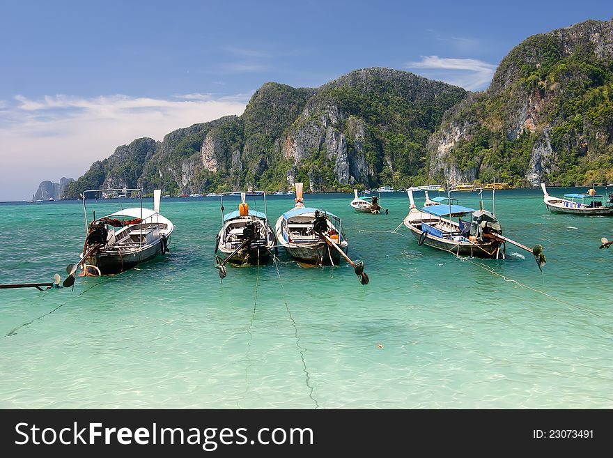 Long tailed boats at Phi Phi island in Thailand .