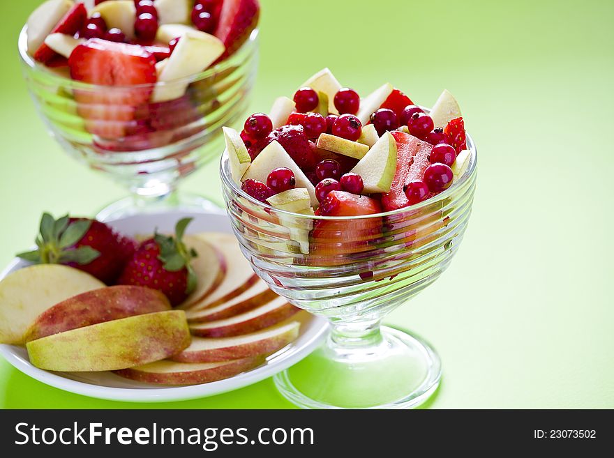 Photograph of two bowls of a colorful fruit salad. Photograph of two bowls of a colorful fruit salad