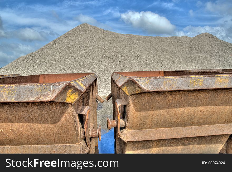 Hill limestone with shipping containers in the foreground with blue sky and clouds background - HDR