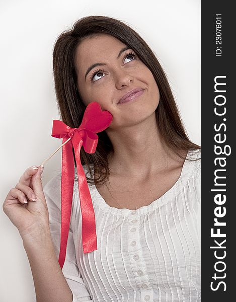 Young girl photographed on white background with Valentine heart