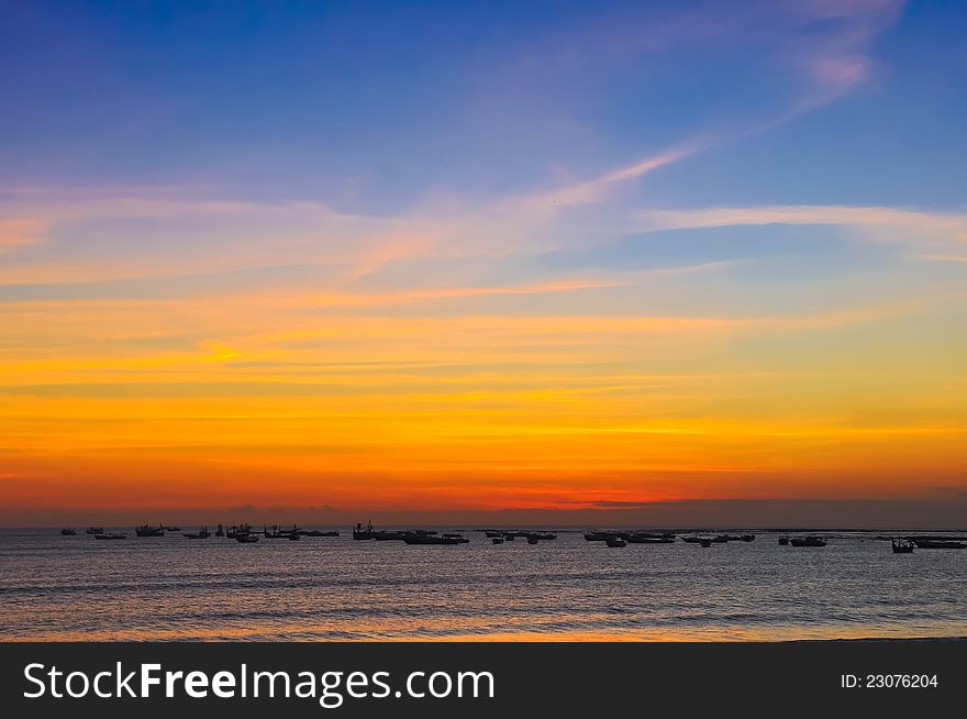 Ocean coast sunset and fishing boats, Jimbaran, Bali