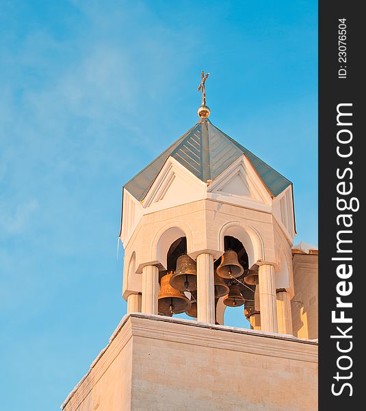 Beautiful bell tower of the temple against the blue sky