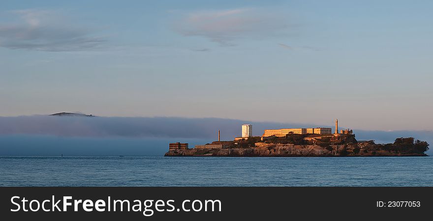 Image of Alcatraz Prison at sunset with fog coming in to San Francisco Bay. Image of Alcatraz Prison at sunset with fog coming in to San Francisco Bay.