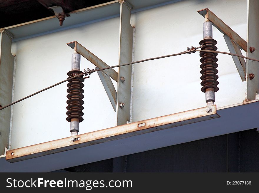 Two electrical insulators on iron construction