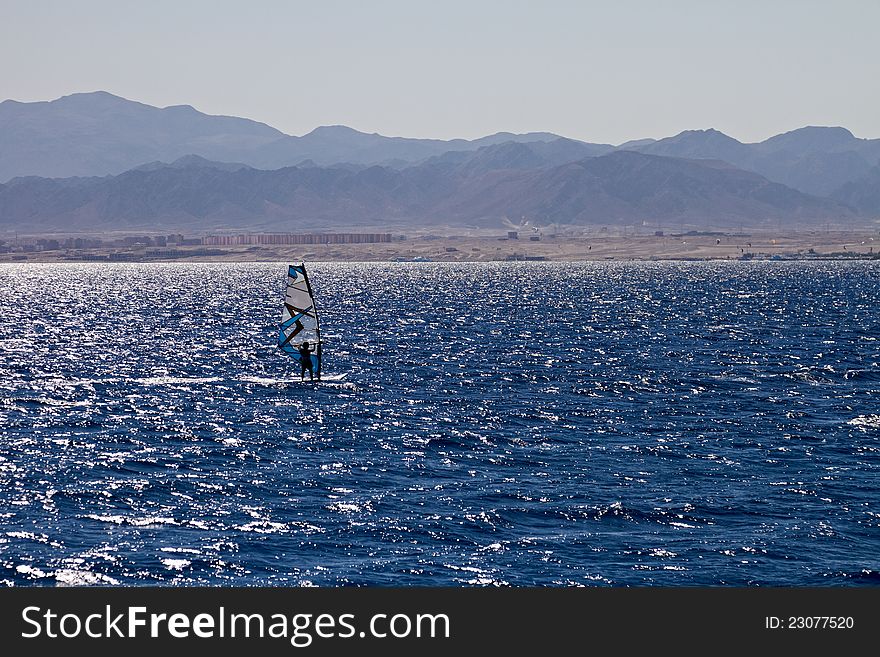 Unidentified man windsurfing in Red Sea waters in Egypt, Safaga, on October 2011. Unidentified man windsurfing in Red Sea waters in Egypt, Safaga, on October 2011