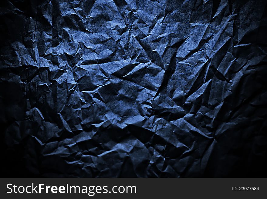 Dark blue scrunched paper background. Dark blue scrunched paper background