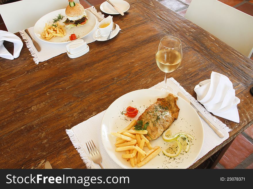 Hamburger with chips and fish and chips