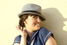 Near The Wall Happy Brunette Girl With Hat Stock Image