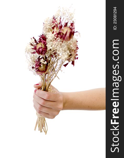 Womans hand holding a beautiful bouquet of dry flowers. BrideÂ´s bouquet after marriage
