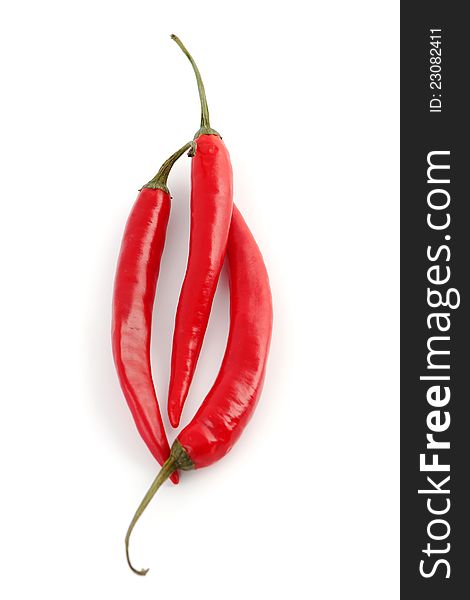 Three hot red chili peppers isolated on a white background