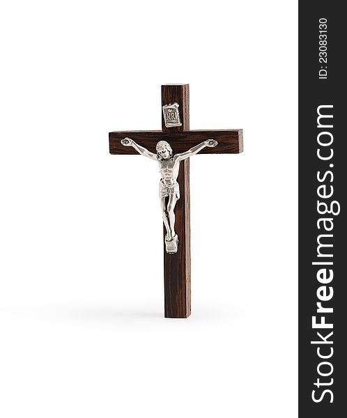 Small wooden crucifix standing on white background. Isolated with clipping path. Small wooden crucifix standing on white background. Isolated with clipping path