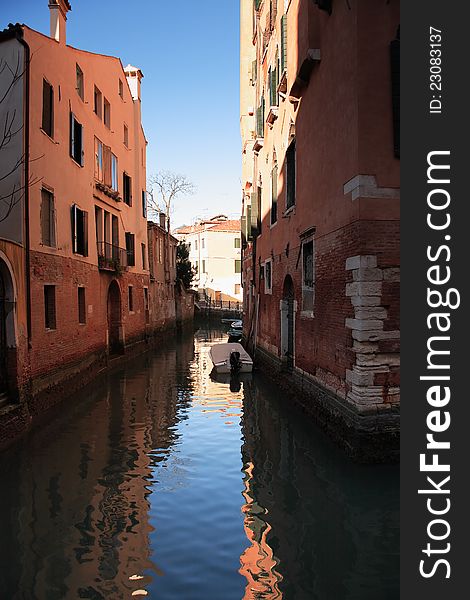 Few boats on a narrow canal between old buildings. Venice, Italy. Few boats on a narrow canal between old buildings. Venice, Italy