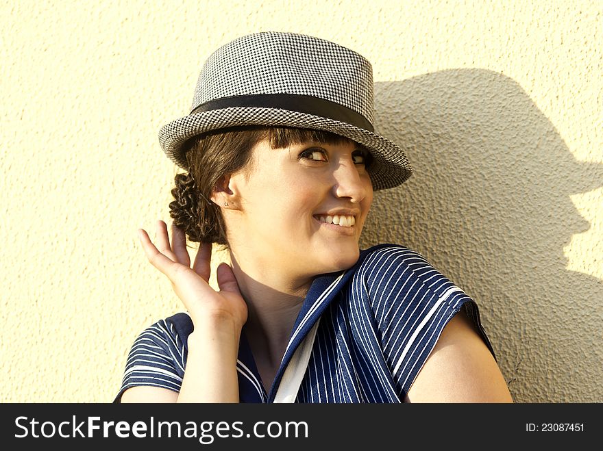 Near The Wall Happy Brunette Girl With Hat