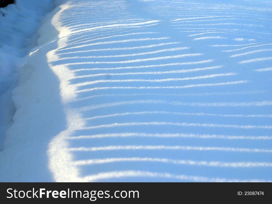 Light and snow creating a beautiful texture. Light and snow creating a beautiful texture