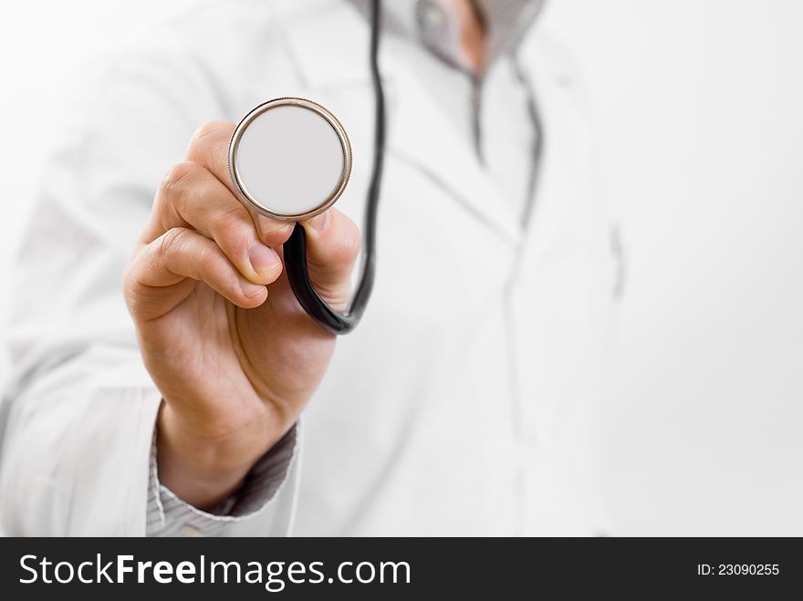 Male doctor holding stethoscope in one hand on white background. Male doctor holding stethoscope in one hand on white background