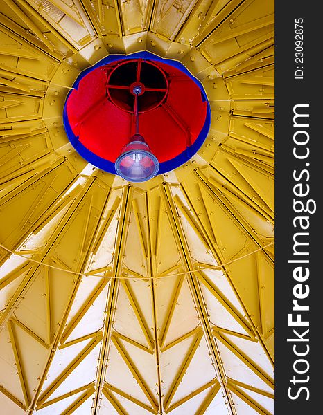 Bright colored red, blue and yellow metal work with center lamp architectural background. Bright colored red, blue and yellow metal work with center lamp architectural background.