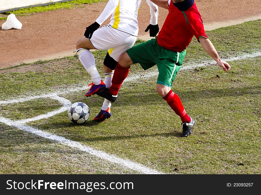 Two players are challenging to get the ball. Two players are challenging to get the ball