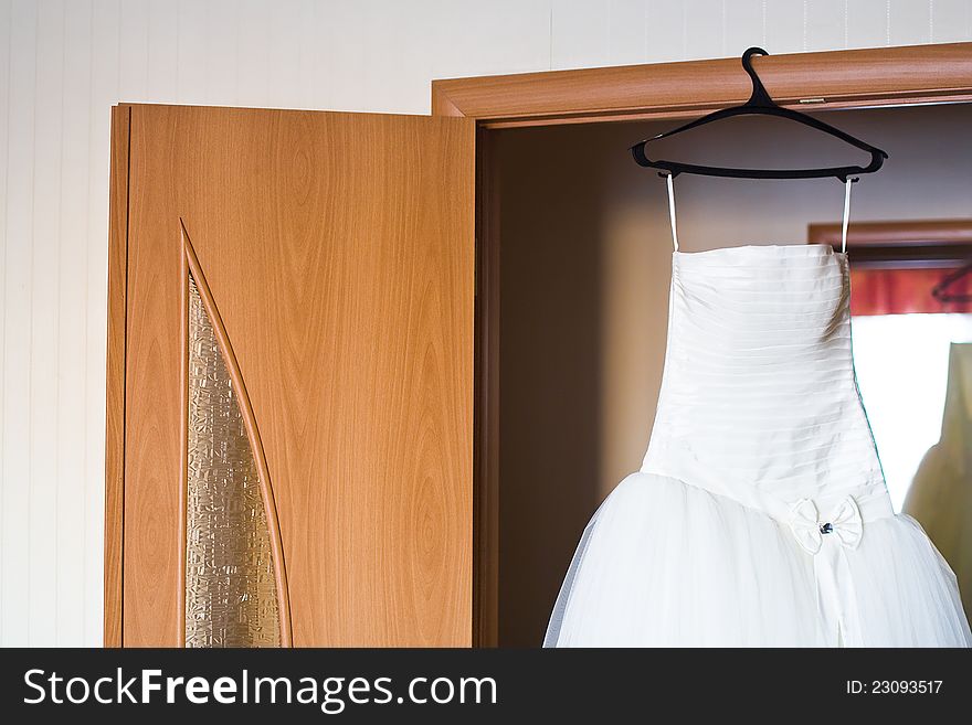 Wedding dress hung up on case