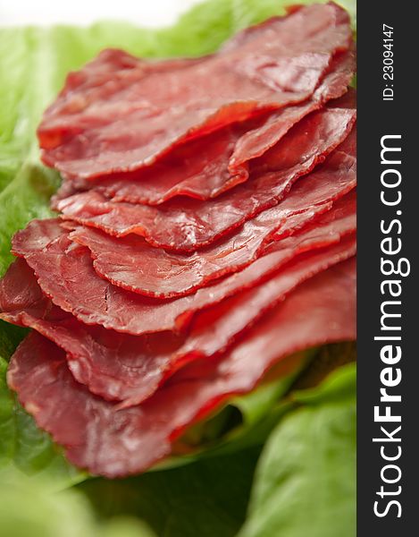 Sliced ​​ham served on lettuce. Sliced ​​ham served on lettuce