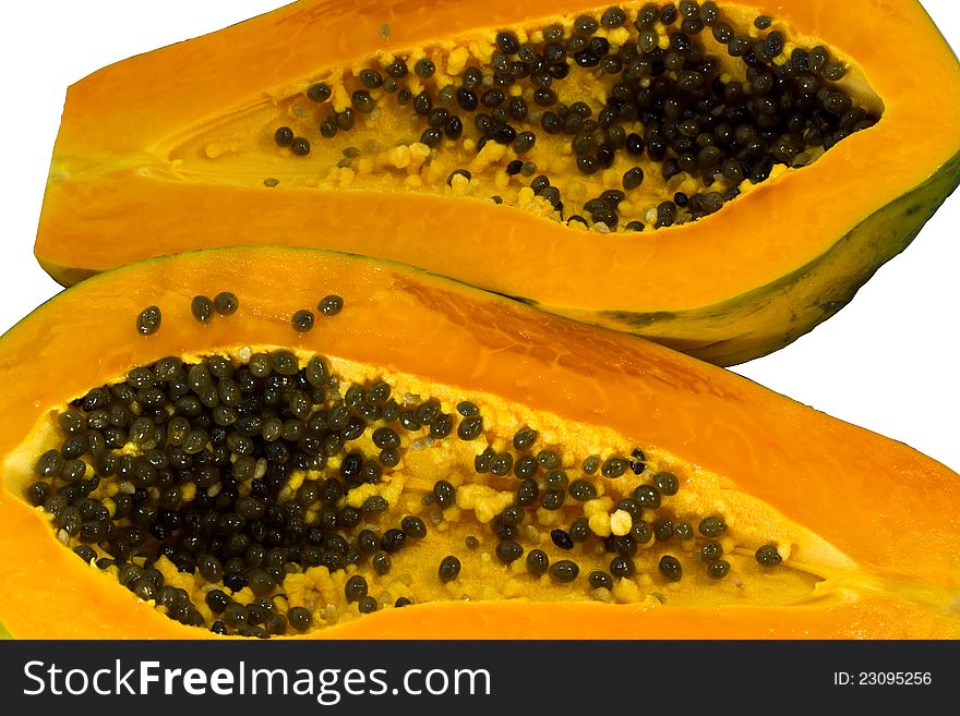 Ripe papaya, cut in half on a white background. Ripe papaya, cut in half on a white background.