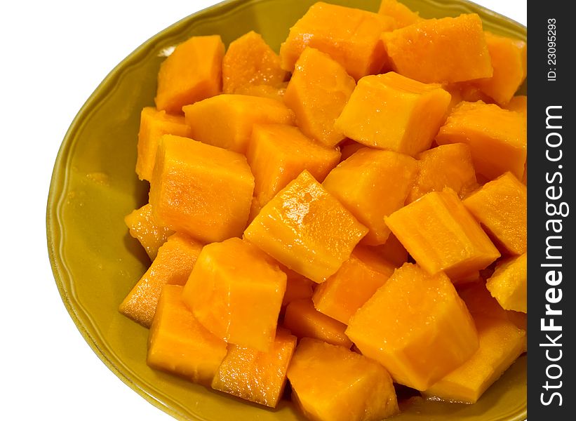 Ripe papaya slices on a plate on a white background. Ripe papaya slices on a plate on a white background.