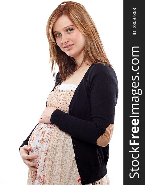 Young pregnant woman smiling and keeping her belly