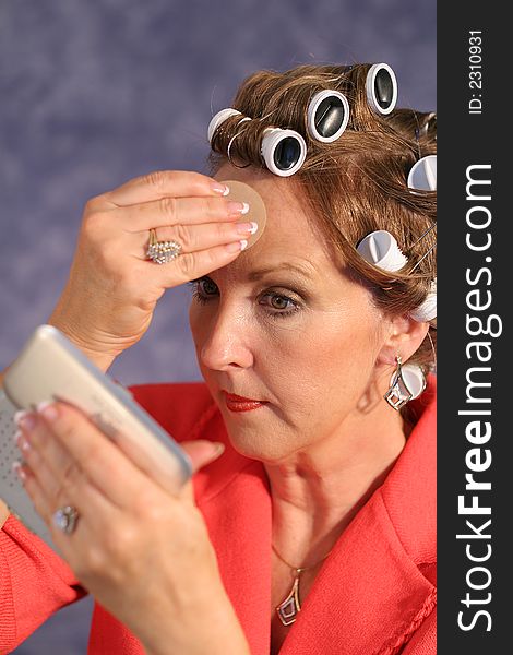 Woman with rollers applying po