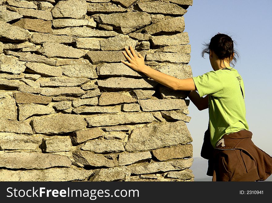 Girl Climbing on an ancient wall